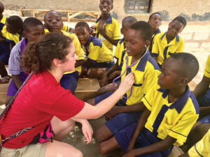 student with school kids in ghana