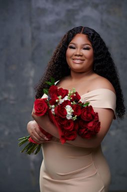 Chelena Meadows, recent graduate of the University of Indianapolis, poses with a bundle of roses.