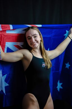 Mikaela Starr, recent graduate of the University of Indianapolis and member of the UIndy Women's Swimming and Diving team, poses holding the Australian flag.