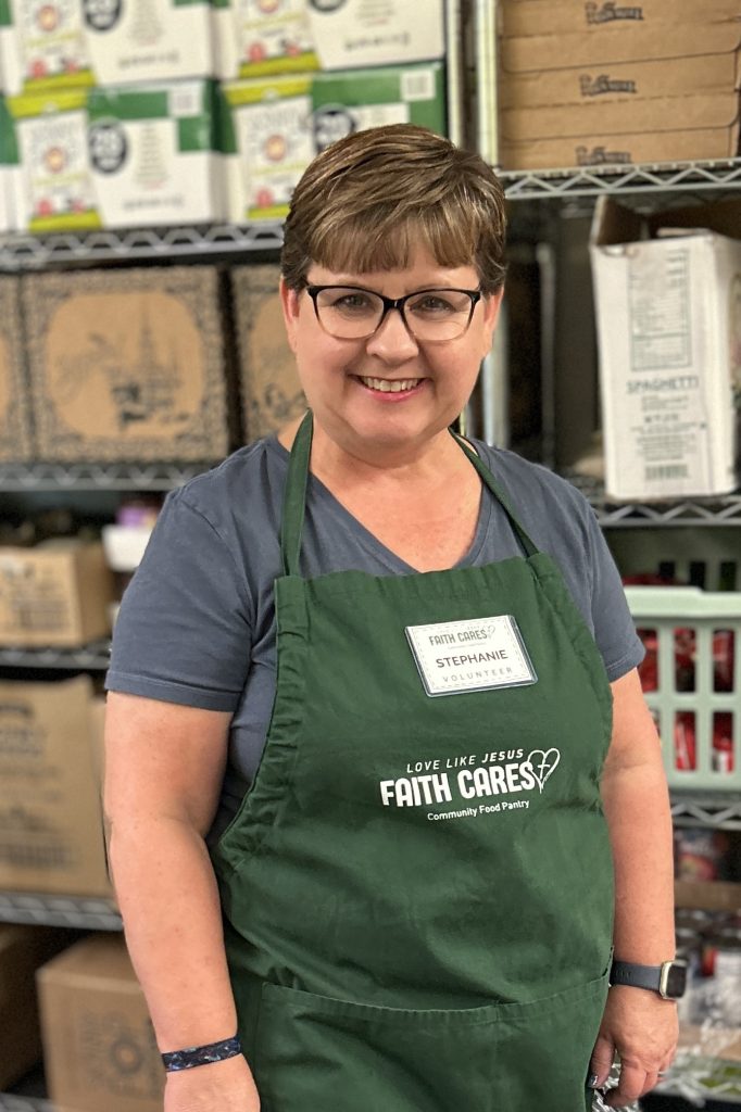 Photo of Stephanie Kendall-Deitz wearing a Faith Cares volunteer apron