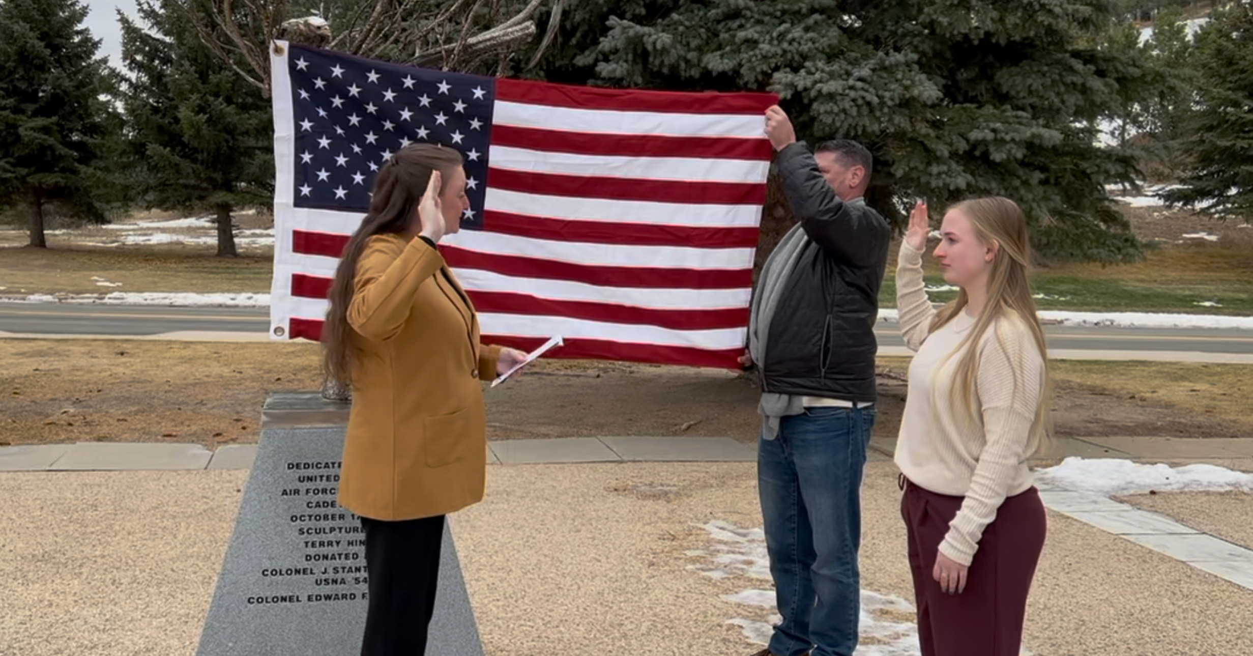 Photo Kelly Lundberg taking her oath of service, administered by her sister, at the U.S. Air Force Academy