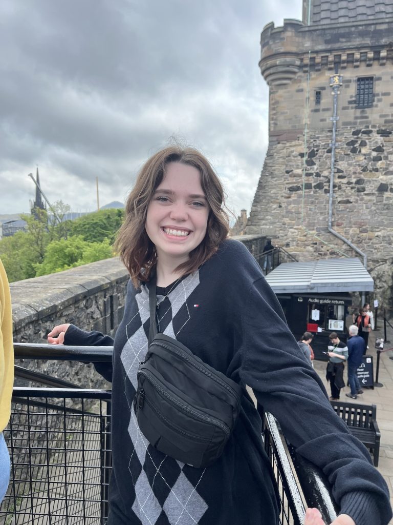 Piper Parks in front of a Scottish castle